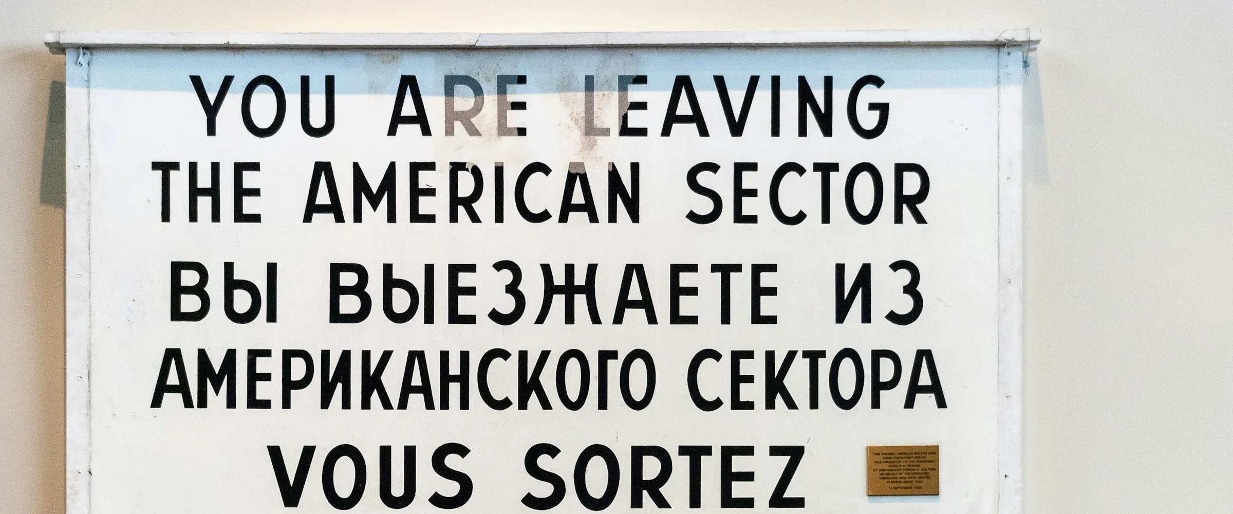 source: https://unsplash.com/photos/white-and-black-quote-board-hpbiThVmsss You are leaving the American sector